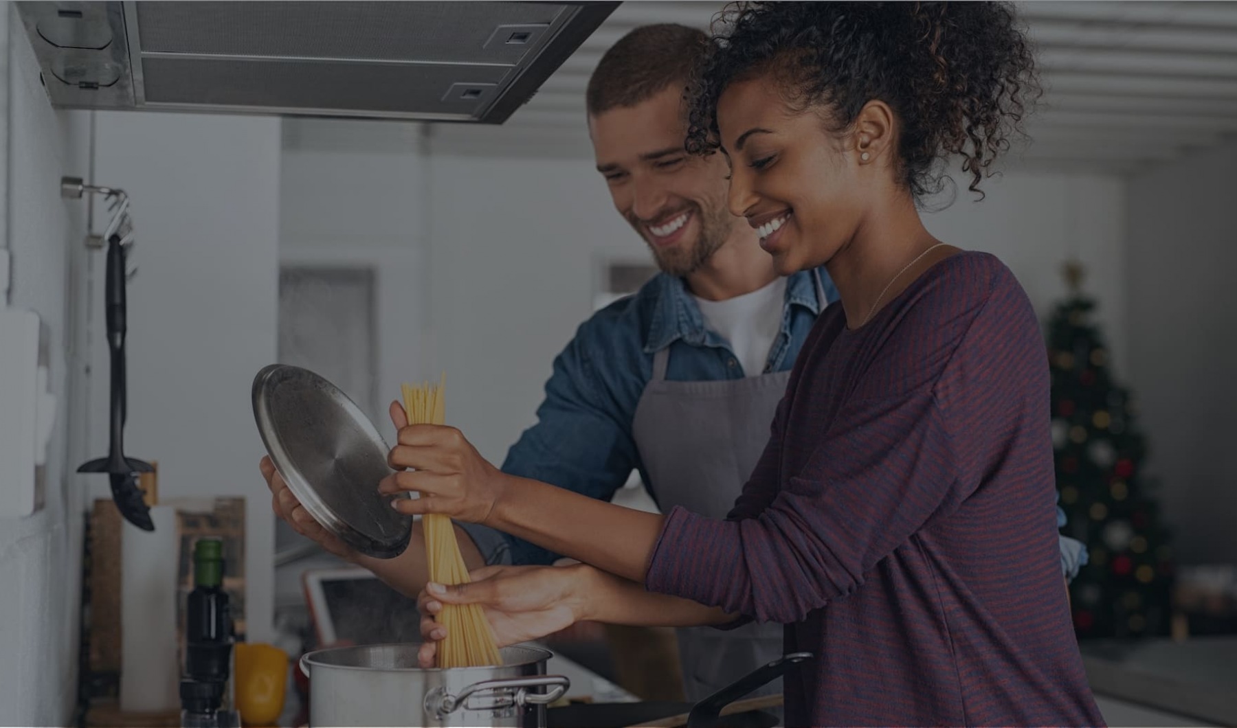 THE PERFECT LIFESTYLE lifestyle image of a couple cooking in a kitchen